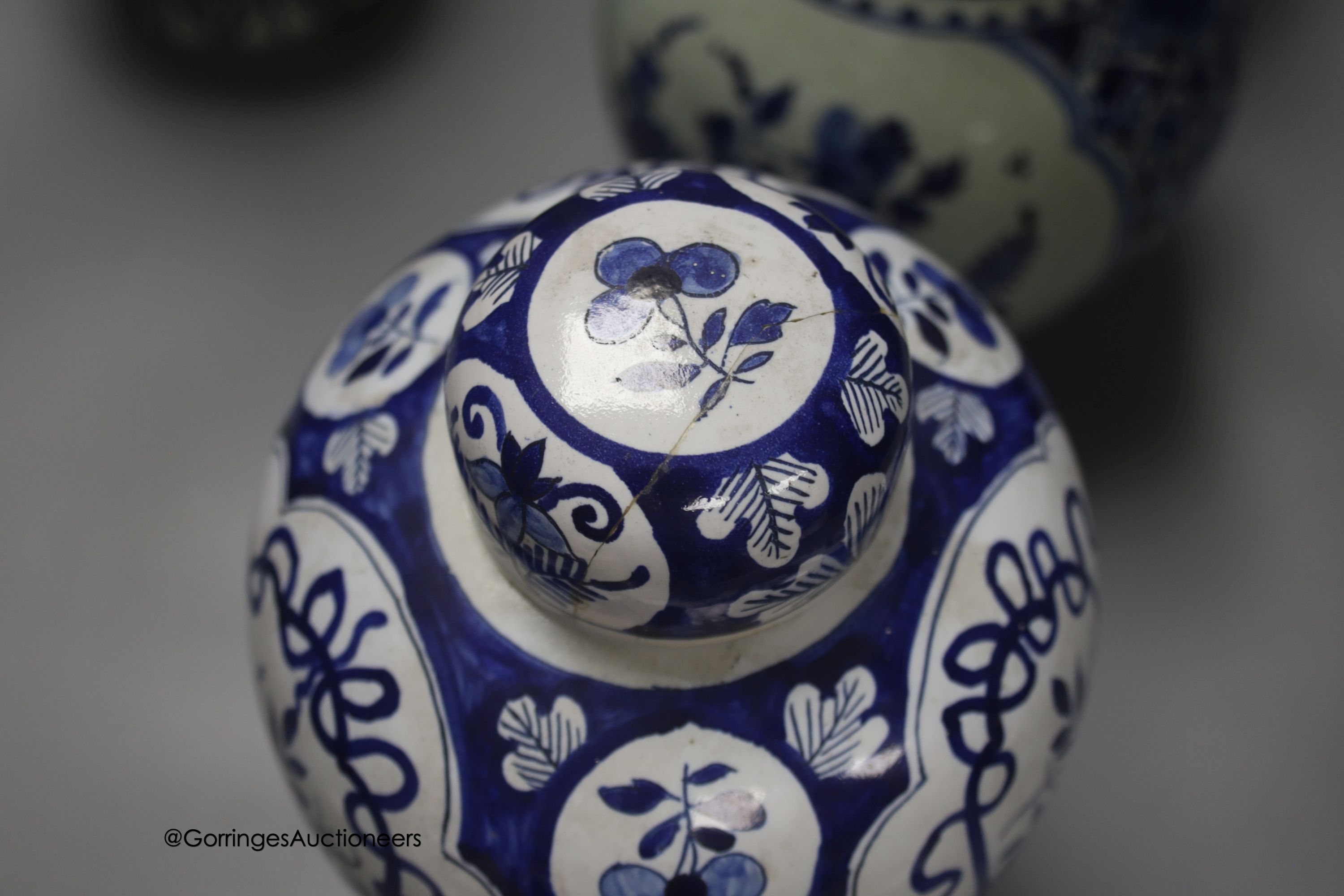 A pair of Dutch Delft blue and white vases, 29cm, a similar ovoid jar and cover and a bulbous jug